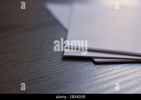 Closeup of blank sheets of paper on a wooden desk with copy space Stock Photo