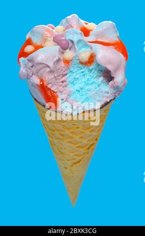 side view marshmallow and raspberry flavor ice cream cone with a bite on blue background Stock Photo