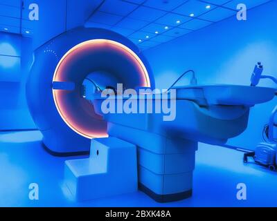 MRI - Magnetic resonance tomography imaging scan device in blue color. Stock Photo