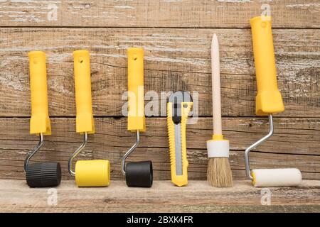 Manual painting tools on wooden background. A paint tool for Wallpaper. Stock Photo