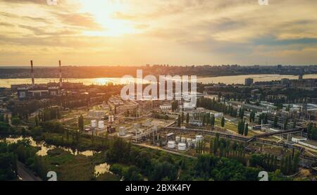 Sunset over European city industrial zone with factories, aerial panorama. Stock Photo