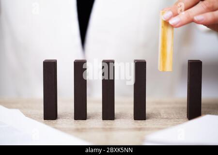 Business concept, woman's hands make up wooden cubes symbolizing the success of the company Stock Photo