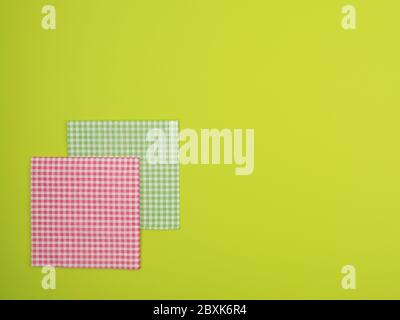 Plaid paper napkins on green background. Stock Photo