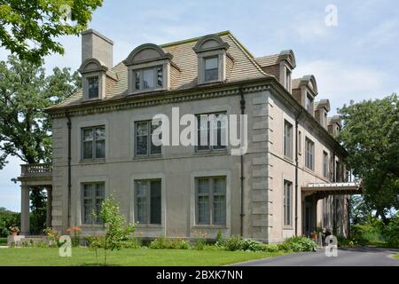 An impressive Beaux Arts style French villa, with a mansard roof with arched dormer windows in small town America, St. Cloud, MN, USA Stock Photo