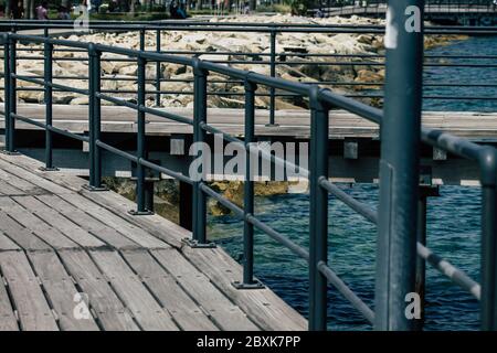 Limassol Cyprus June 07, 2020 View of the renovated wooden pier extensions allowing people to walk over the sea on Limassol promenade in the afternoon Stock Photo