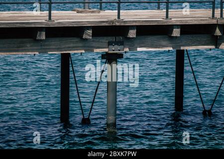 Limassol Cyprus June 07, 2020 View of the renovated wooden pier extensions allowing people to walk over the sea on Limassol promenade in the afternoon Stock Photo