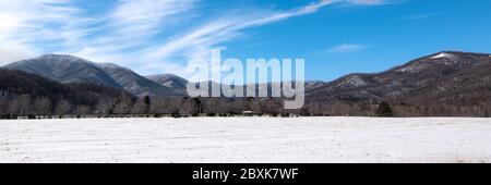 Snowy countryside farm in Virginia under blue skies Stock Photo