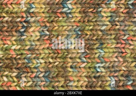 Warm green beige blue pink knitted wool melange blend handmade garment background, large detailed horizontal colorful textured woolen knitwear pattern Stock Photo