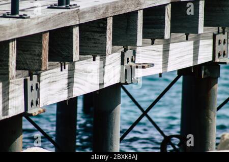 Limassol Cyprus June 07, 2020 View of the renovated wooden pier extensions allowing people to walk over the sea on Limassol promenade in the afternoon Stock Photo