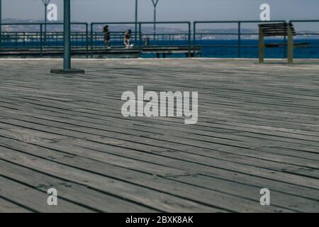 Limassol Cyprus June 07, 2020 View of the renovated wooden pier extensions allowing people to walk over the sea on Limassol promenade in the afternoon Stock Photo