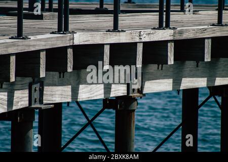 Limassol Cyprus June 07, 2020 View of the renovated wooden pier extensions allowing people to walk over the sea on Limassol promenade in the afternoon Stock Photo