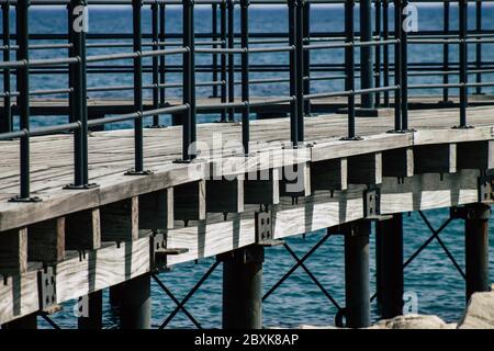 Limassol Cyprus June 07, 2020 View of the renovated wooden pier extensions allowing people to walk over the sea on Limassol promenade in the afternoon Stock Photo