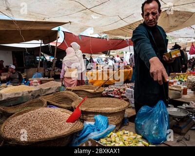 FEZ, MOROCCO - CIRCA MAY 2018:  Merchants and buyers on a typical market in the outskirts of Fez in Morocco Stock Photo