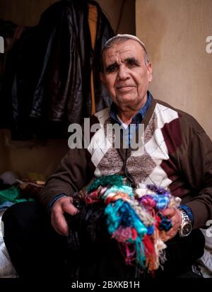 FEZ, MOROCCO - CIRCA MAY 2018: Portrait of Moroccan merchant at the Medina in Fez Fes el Bali. is the oldest walled part of Fez, Morocco. Stock Photo