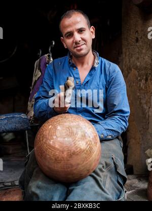 FEZ, MOROCCO - CIRCA MAY 2018: Portrait of Moroccan metal worker at the Medina in Fez. Fes el Bali. is the oldest walled part of Fez, Morocco. Stock Photo