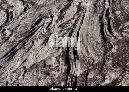 Natural sandstone rock rippled textured surface ideal as background Stock Photo