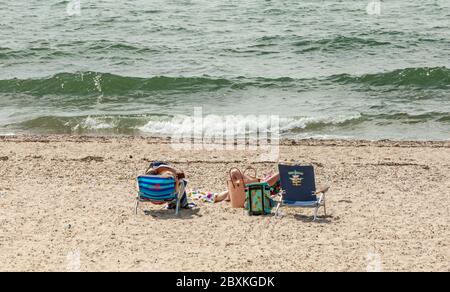 Two people on the beach, Hay Beach, Shelter Island, NY Stock Photo