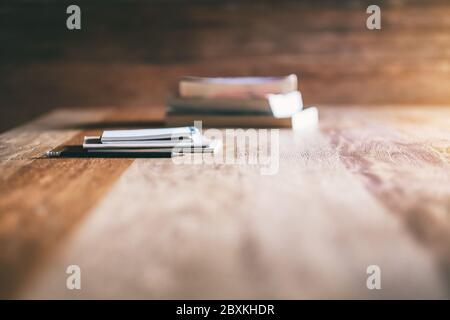 Books and notebooks on wooden table Stock Photo