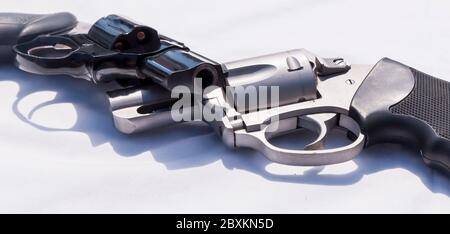 Two handguns, a stainless steel 357 and a black 38 special revolver on a white background Stock Photo