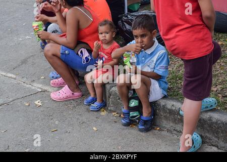 Members of 'Jesús Pescador de Hombres' foundation giving food aid to stranded Venezuelans in Cali. The organisation prepares and distributes hundreds Stock Photo