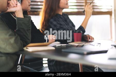 Businesspeople looking and discussing ideas over a board in office Stock Photo