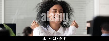 Excited African employee received long awaited great news feels happy Stock Photo