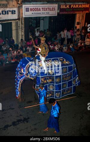 A beautifully dressed ceremonial elephant parades down Colombo Street in Kandy, Sri Lanka during the Buddhist Esala Perahera. Stock Photo
