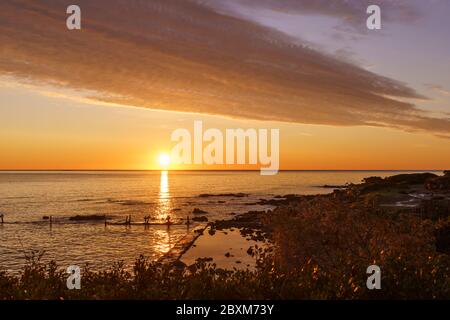 Orange sky with gorgeous cloud on an old sea pier in dawn or sunset Stock Photo