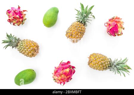 Tropical fruit pattern with pineapple, mango and dragon fruits on white background. Flat lay, top view Stock Photo