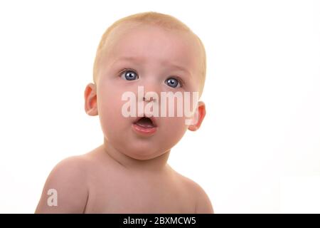 Baby give questioning look to the camera. Studio portrait over white. Stock Photo