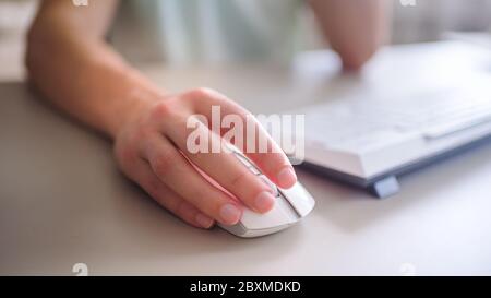 the developer works at the computer, uses mouse Stock Photo