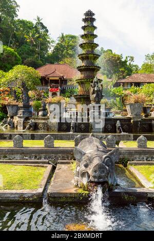 Rakshasa demon stone statue and fountain. Stone statue from hindu myths in Tirta gangga water palace. Bali, Indonesia Stock Photo