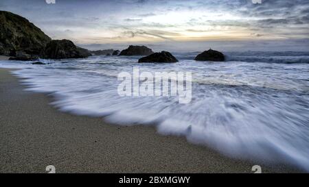 Long exposure capture of a wave coming in to shore at Bodega Bay, California. Stock Photo