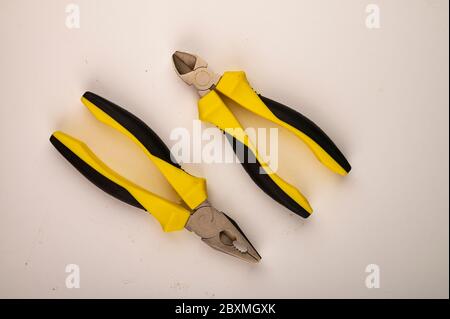 Different pliers on a white background. Close up. Manual locksmith and installation tools for home work Stock Photo
