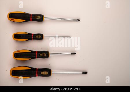 Different screwdrivers on a white background. Close up. Manual locksmith and installation tools for home work Stock Photo