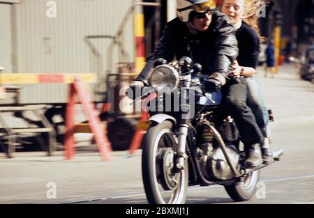 In the 1960s. A young man on his motorcycle with a girl sitting on the back seat. Sweden 1968 CV31 Stock Photo