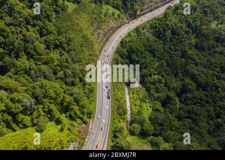 Aerial view of the beautiful North South highway cutting through mountainous tropical jungle in Perak State, Malaysia Stock Photo