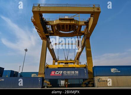(200608) -- BEIJING, June 8, 2020 (Xinhua) -- A crane loads containers at the Manzhouli Railway Station in Manzhouli, north China's Inner Mongolia Autonomous Region, April 13, 2020. Initiated in 2011, the China-Europe rail transport service is considered a significant part of the Belt and Road Initiative to boost trade between China and countries participating in the program. Amid the coronavirus pandemic, the service remained a reliable transportation channel as air, sea and road transportation have been severely affected. The freight trains have also been playing a crucial role in helpin Stock Photo