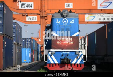 (200608) -- BEIJING, June 8, 2020 (Xinhua) -- A China-Europe freight train bound for Barcelona of Spain waiting for departure in Xi'an, northwest China's Shaanxi Province, April 8, 2020. Initiated in 2011, the China-Europe rail transport service is considered a significant part of the Belt and Road Initiative to boost trade between China and countries participating in the program. Amid the coronavirus pandemic, the service remained a reliable transportation channel as air, sea and road transportation have been severely affected. The freight trains have also been playing a crucial role in h Stock Photo