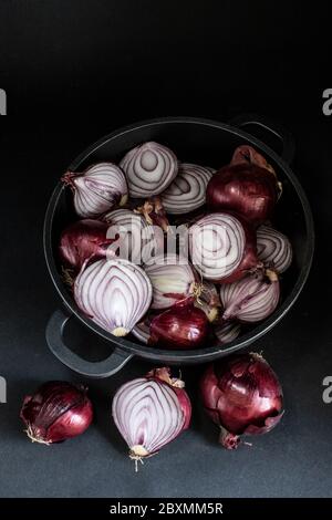 sliced red onions on black ground Stock Photo