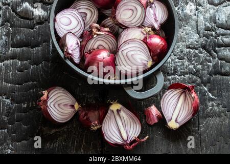 sliced red onions on black ground Stock Photo