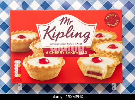 Mr Kipling 6 cherry bakewells on a blue gingham background Stock Photo