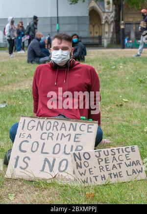 Young protester with sign at the Black Lives Matter demonstration in London, in protest of the death of Black American George Floyd by US police. Stock Photo
