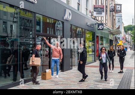 Cork, Ireland. 8th June, 2020. Many shops in Ireland are re-opening today after a 3 month closure due to the Covid-19 pandemic. Staff prepare to enter JD Sports in Patrick Street, Cork. Credit: AG News/Alamy Live News Stock Photo