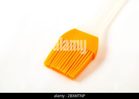 Culinary brush yellow isolated on white. Cutlery concept. Stock Photo