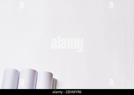 Rolled engineering drawings at white background with copy space. Stock Photo