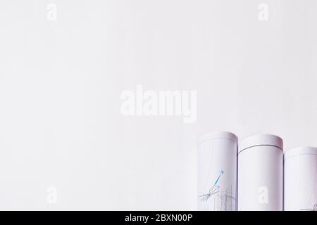 Rolled engineering drawings at white background with copy space. Stock Photo
