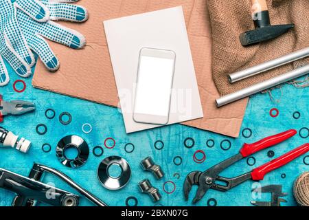 Plumbing DIY tutorial app smartphone mock up, mobile phone with blank screen, top view Stock Photo