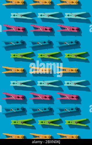 Clothes pins as pattern on blue background Stock Photo