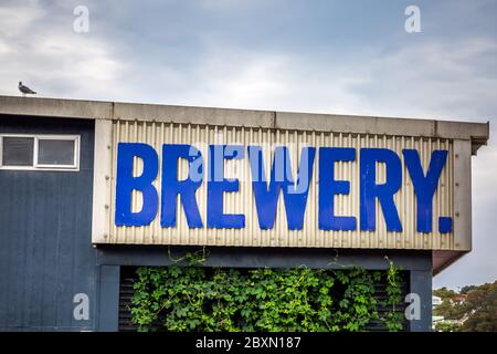 Old rusty brewery sign at Oamaru in the South Island of New Zealand. Omaru is home to the steam punk. Stock Photo